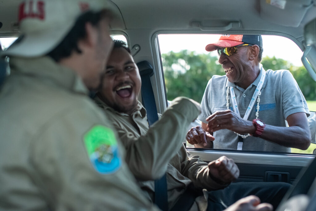 Girringun Rangers sit in a car and share a laugh with a Fijian delegate 